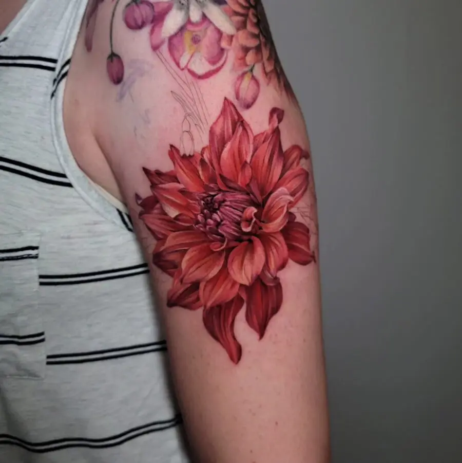 Vibrant dahlia tattoo showcasing rich red hues