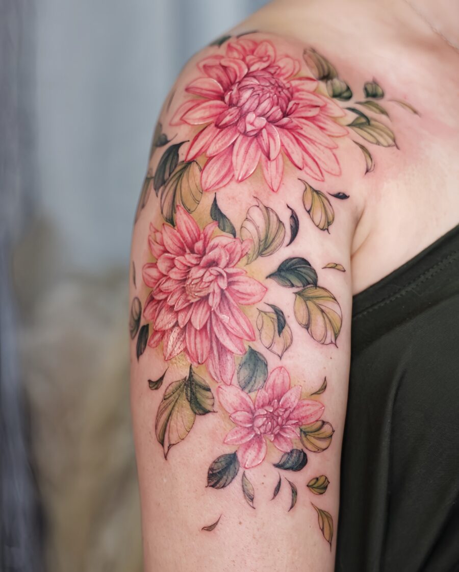 Vibrant dahlia tattoo blooming on shoulder