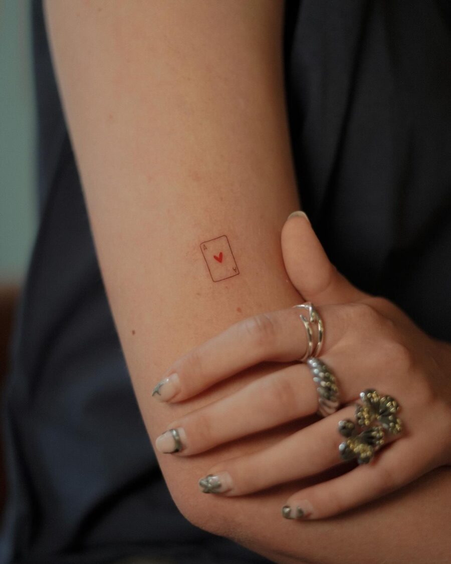 Minimalist heart card tattoo on the arm