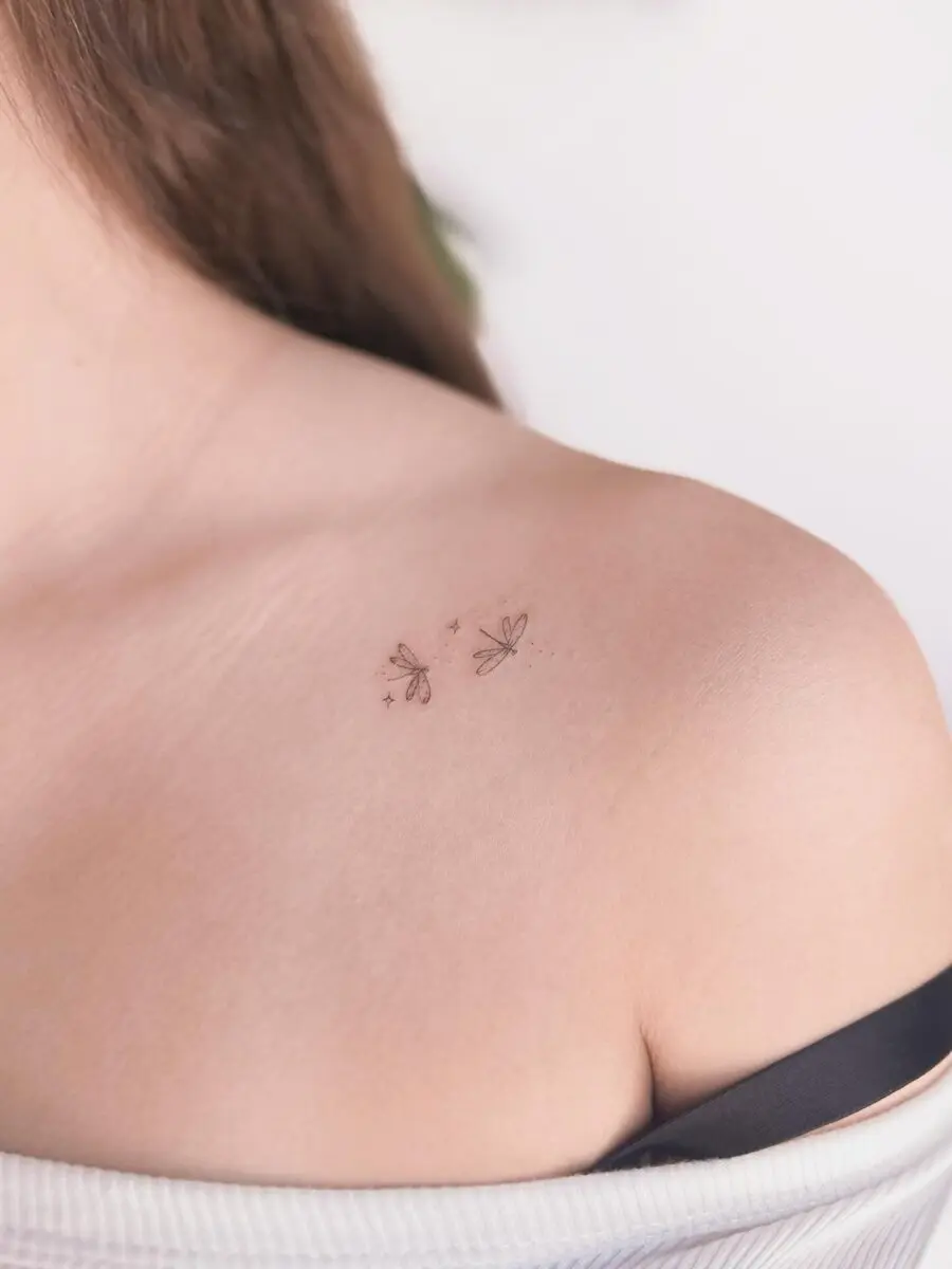 Delicate dragonfly tattoo on shoulder