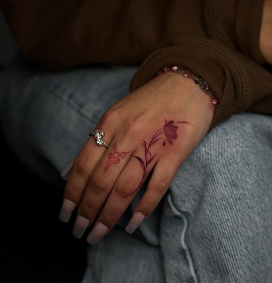 Delicate floral designs on hand tattoos