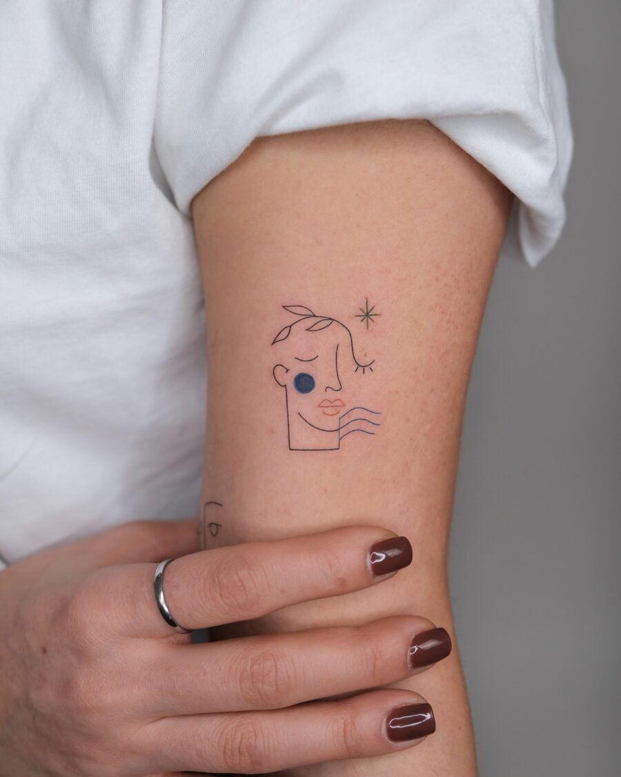 Minimalist face tattoo with artistic flair