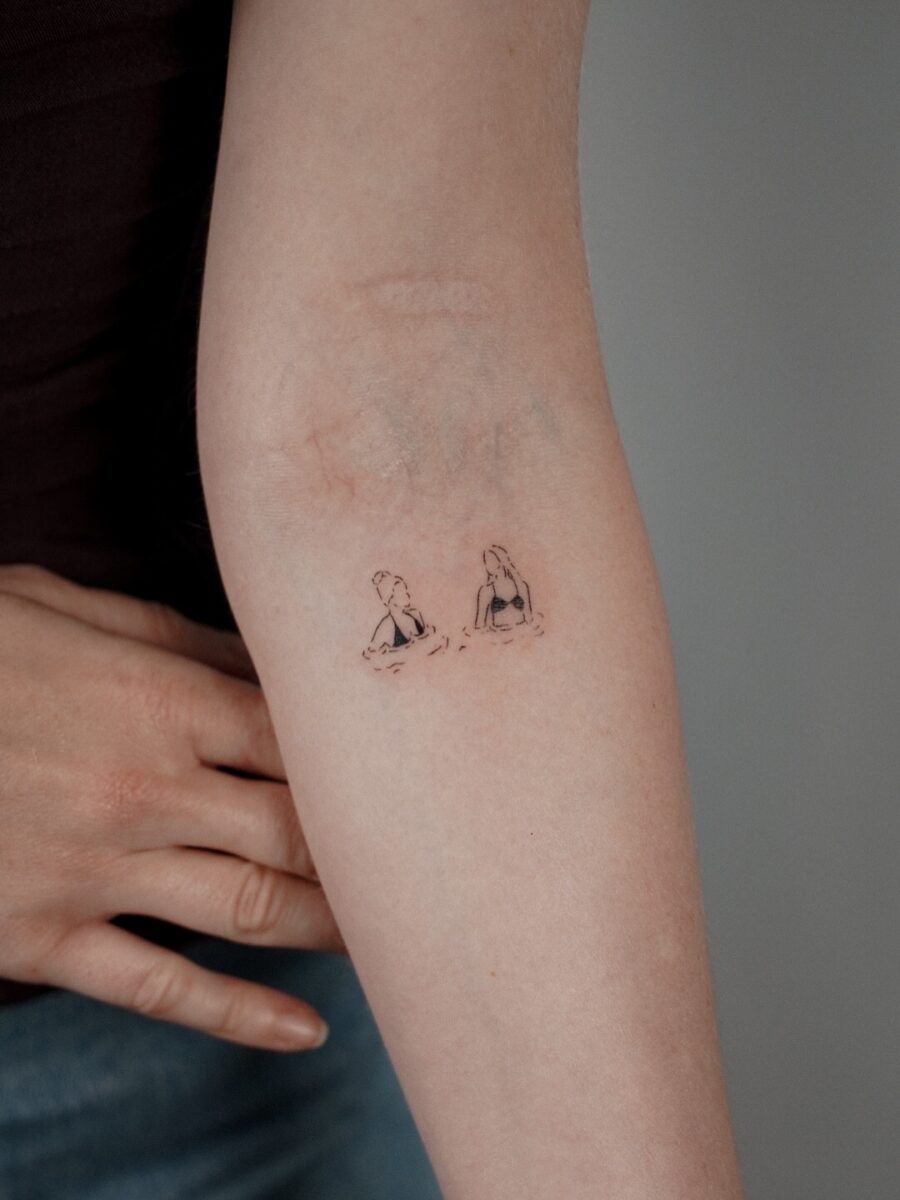 Charming Elbow Tattoo Featuring Two Girls