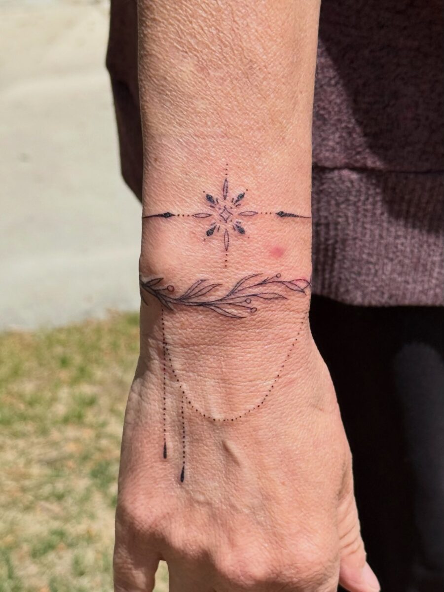 Delicate floral wrist tattoo with intricate details