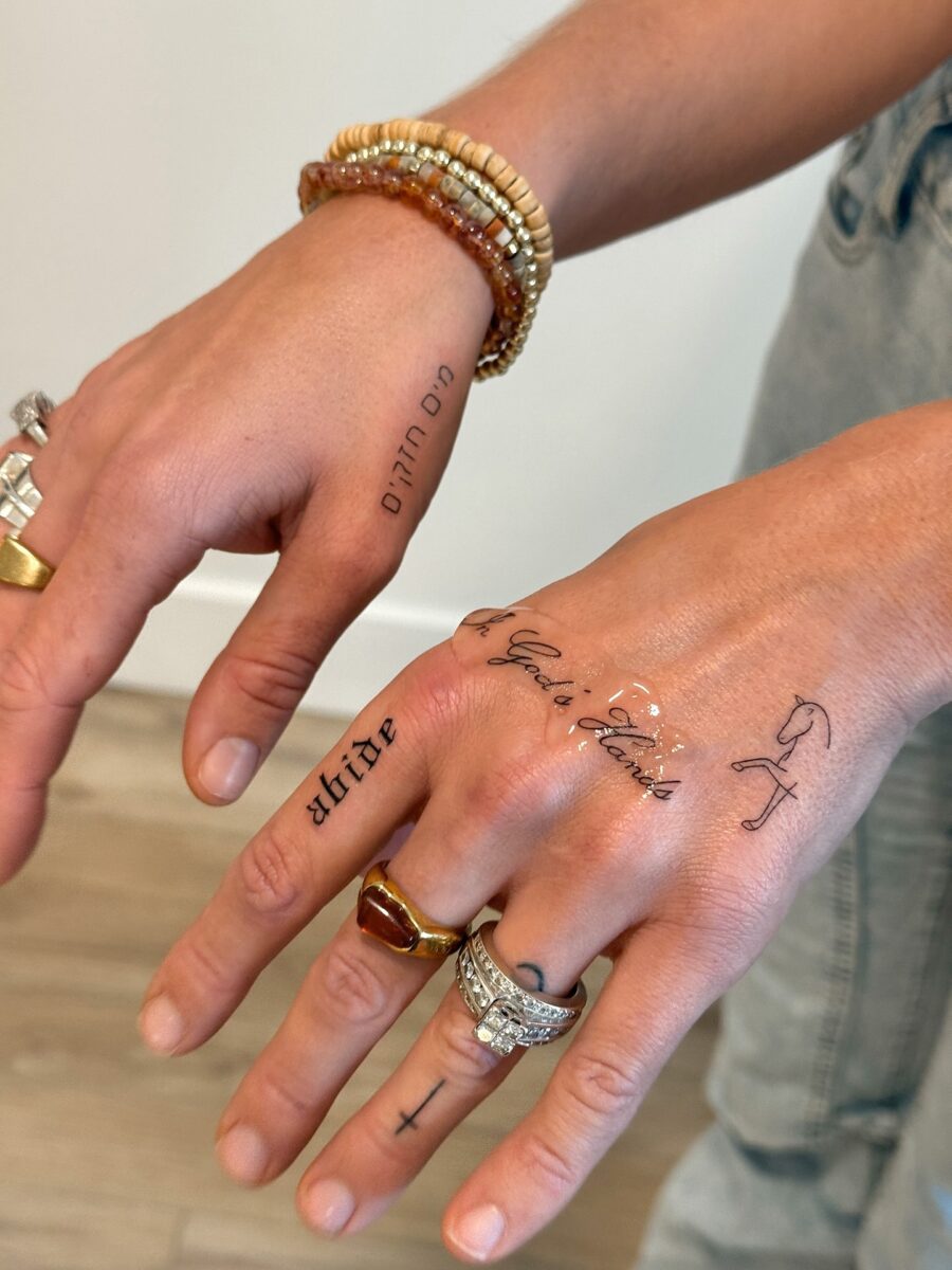 Elegant dainty tattoos adorn stylish hands