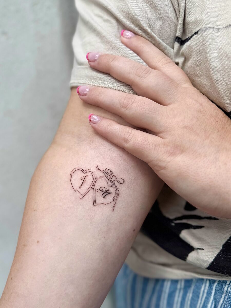 Charming heart-shaped tattoo with bow detail