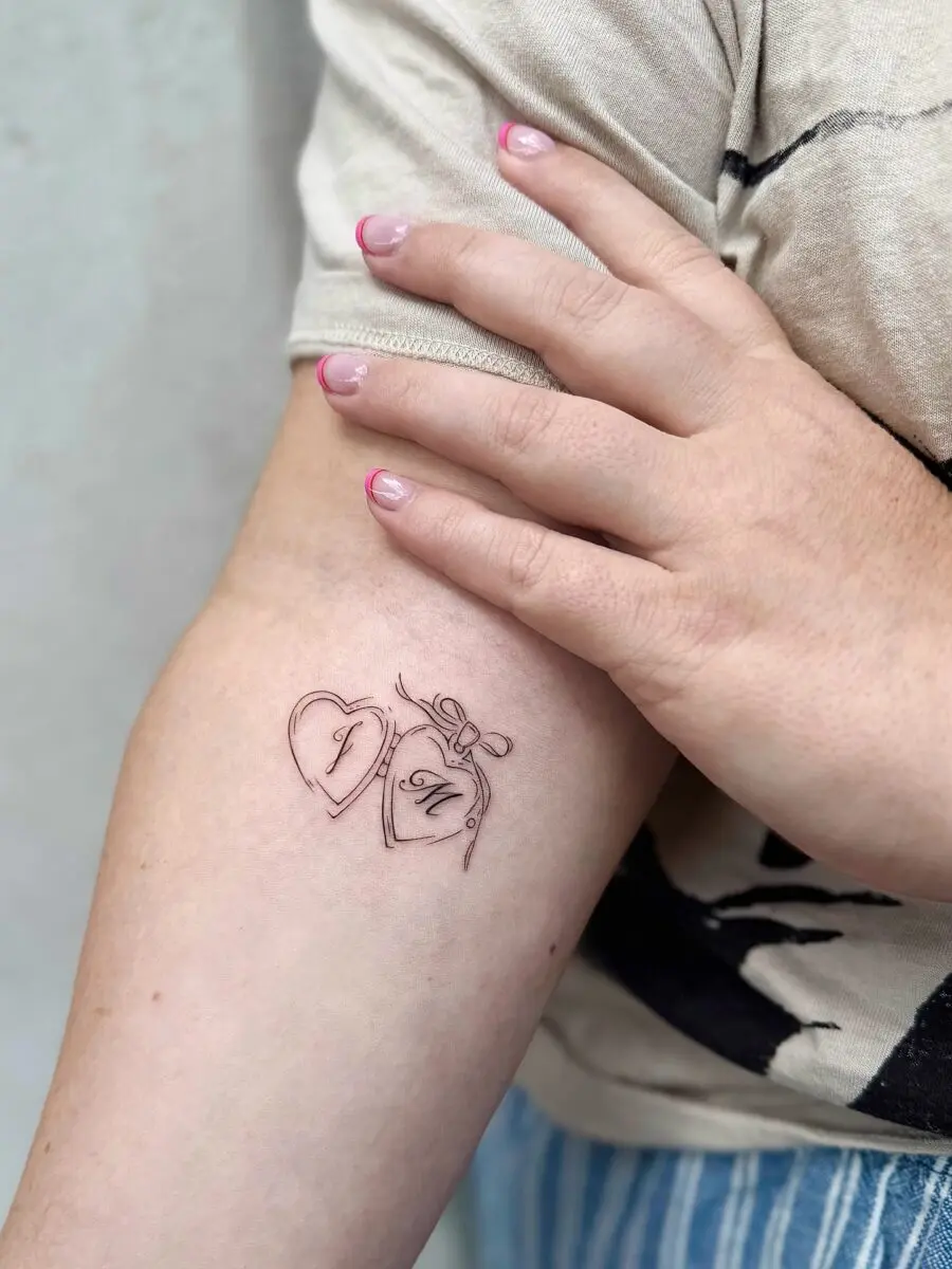 Charming heart-shaped tattoo with bow detail