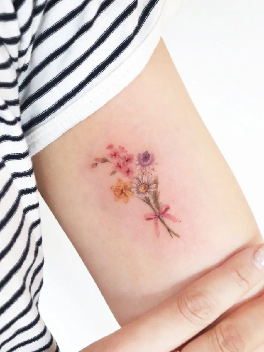 Charming floral tattoo showcasing birth flowers.