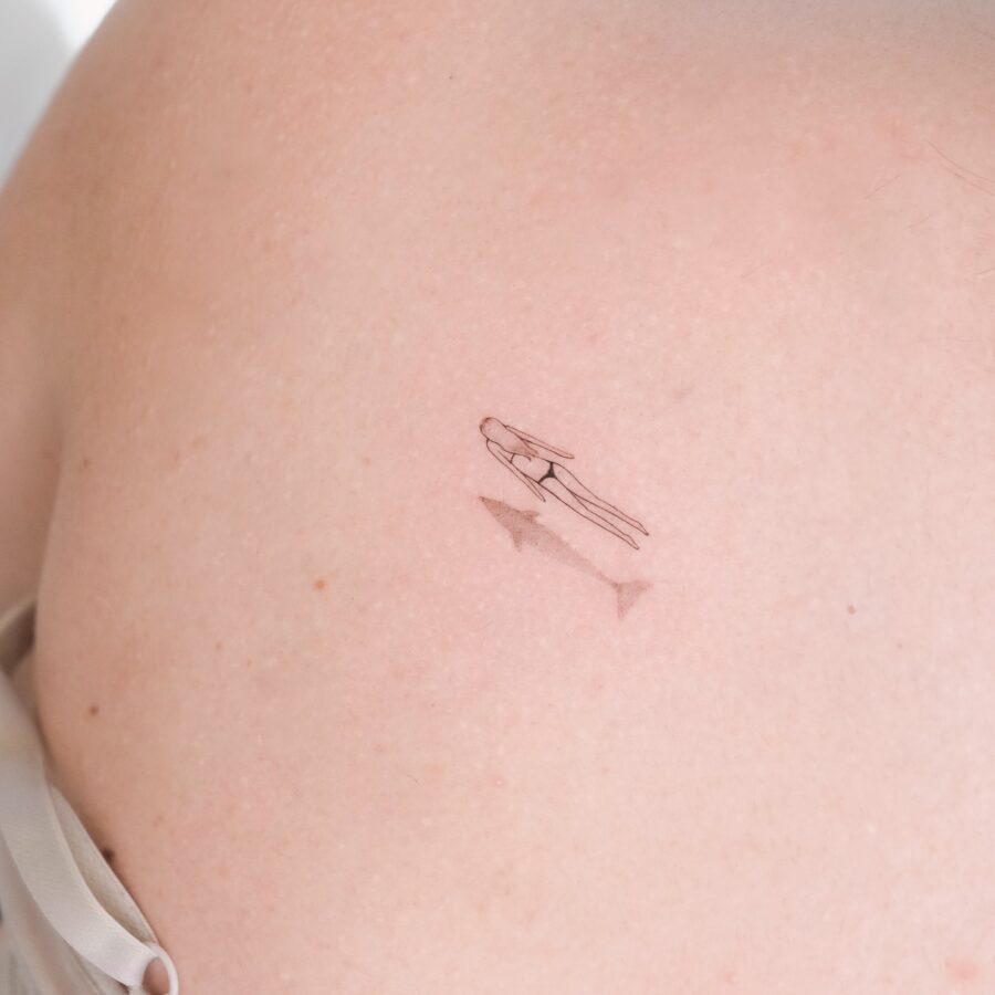 Minimalist silhouette tattoo on bare skin