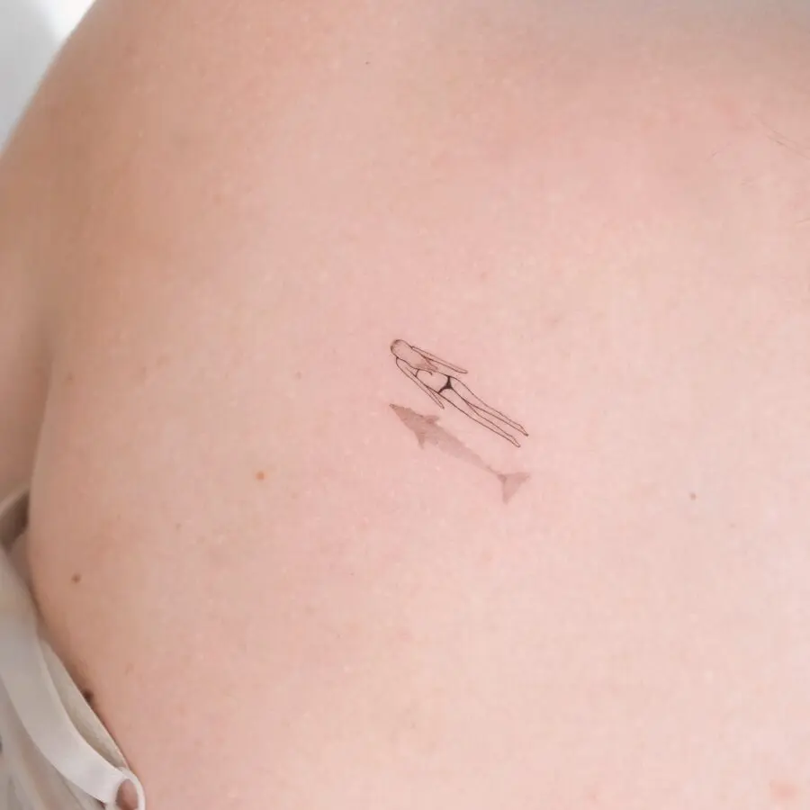 Minimalist silhouette tattoo on bare skin