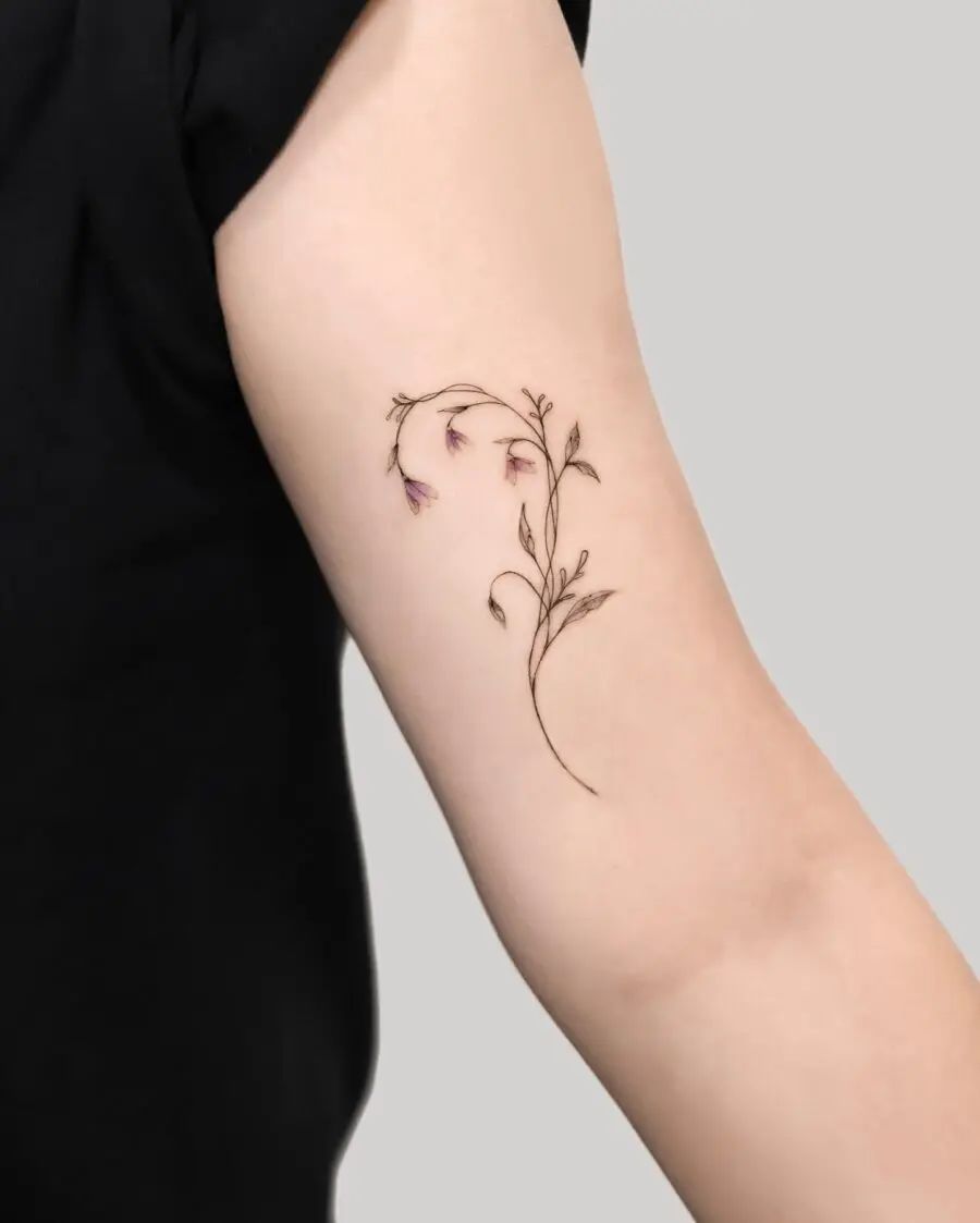 Elegant snowdrop floral tattoo on the arm