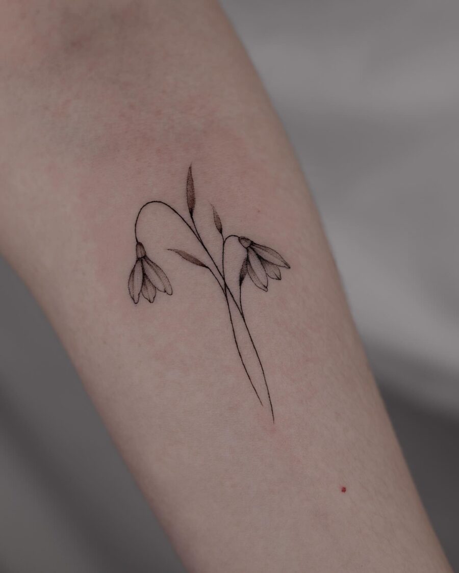 Elegant snowdrop tattoo with fine detailing