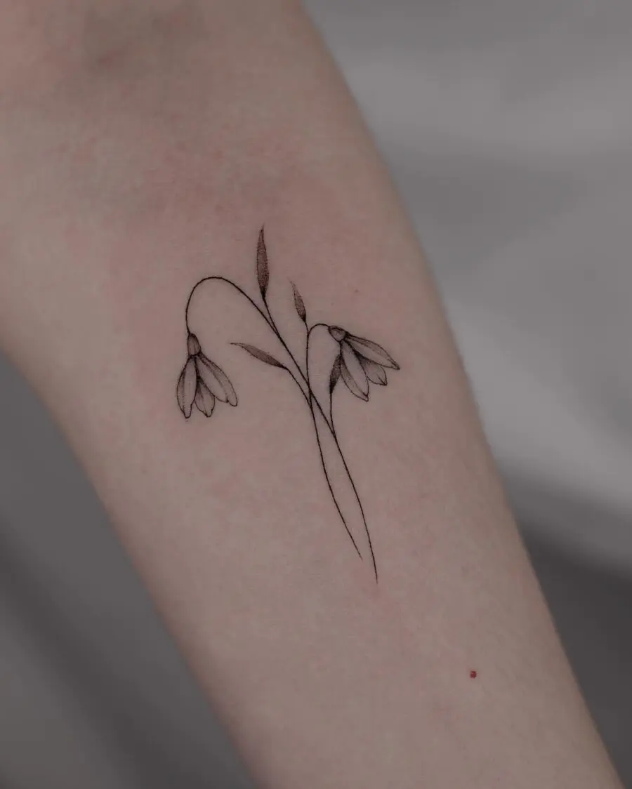 Elegant snowdrop tattoo with fine detailing