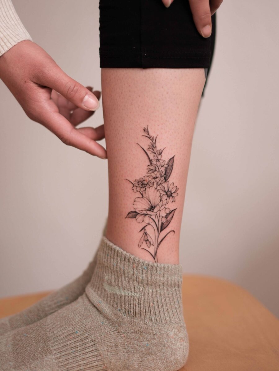 Elegant snowdrop flower tattoo on the leg