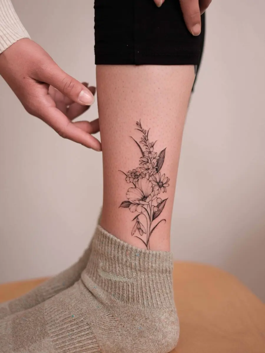 Elegant snowdrop flower tattoo on the leg