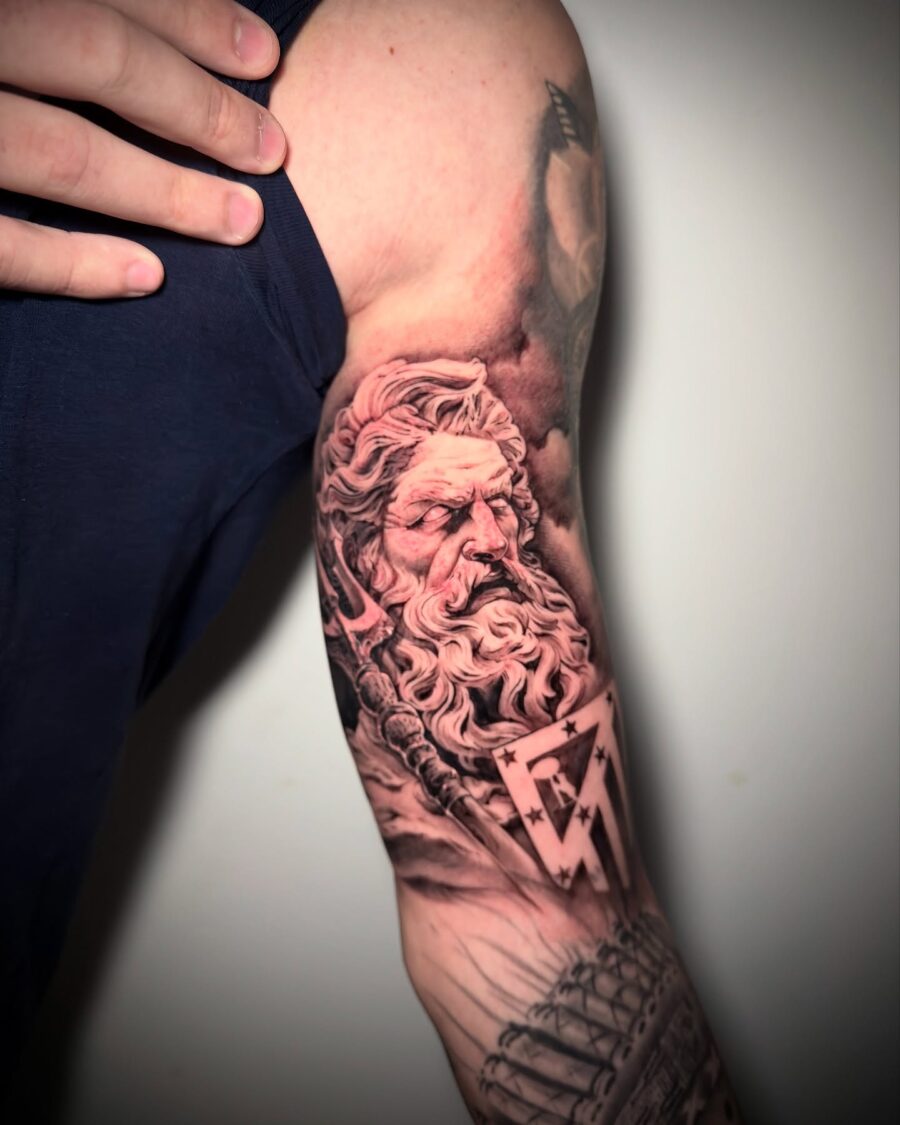 Epic Greek god tattoo on muscular bicep