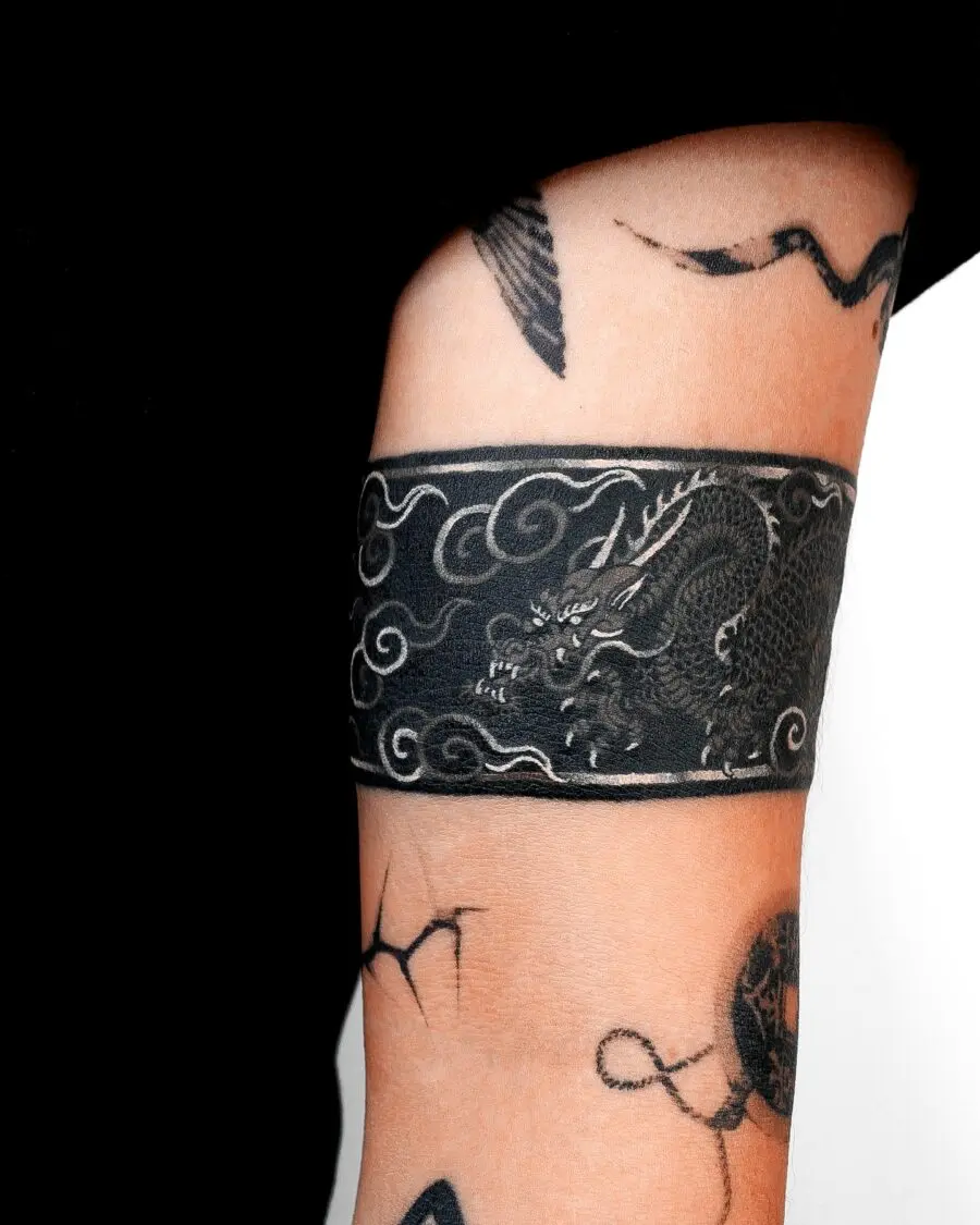 Stylish black ink dragon tattoo cover-up