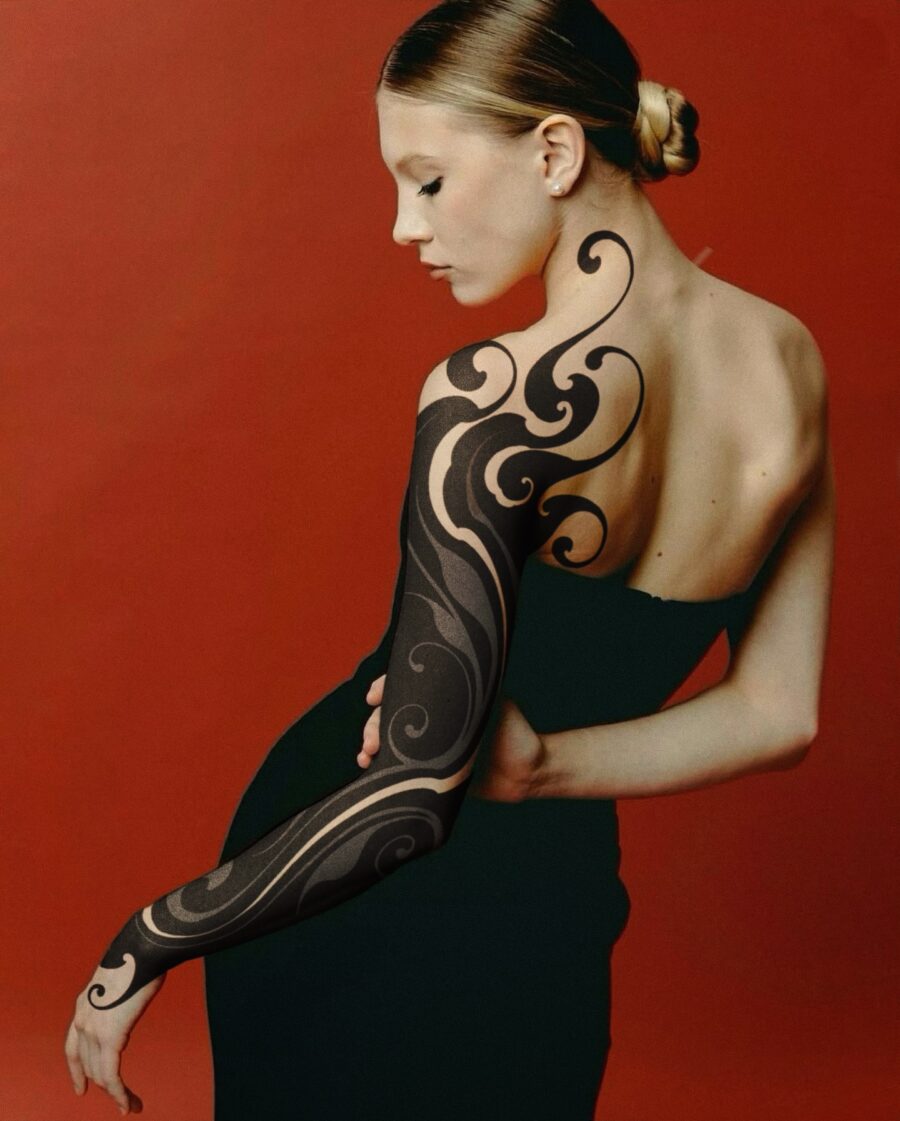 Elegant swirling black sleeve tattoo design
