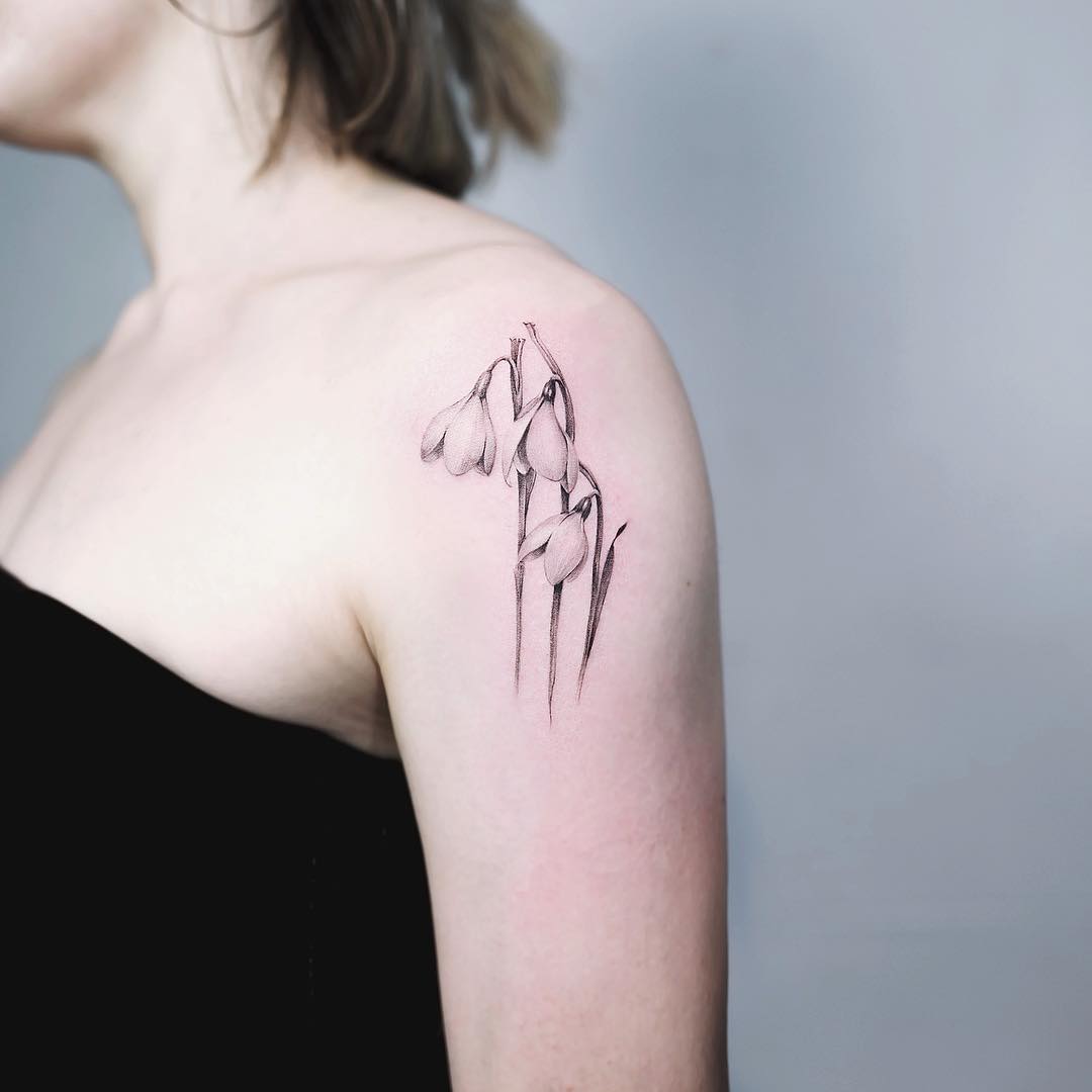 Intricate snowdrop flower tattoo on the shoulder