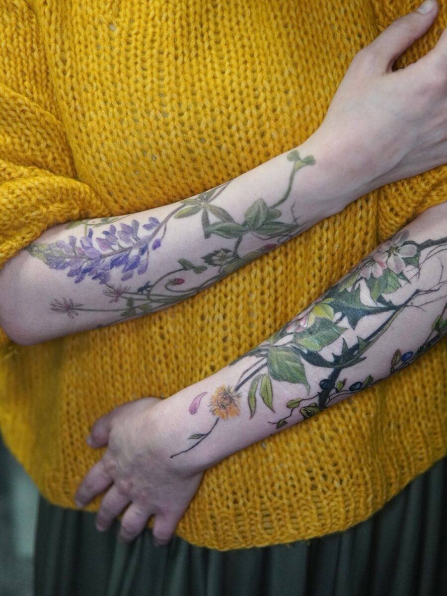 Elegant floral tattoos on soft fabric backdrop