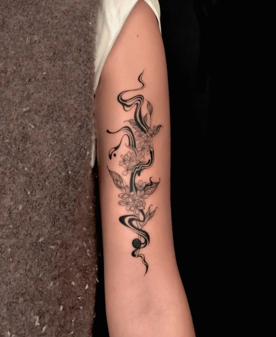 Elegant floral tattoo with flowing designs.