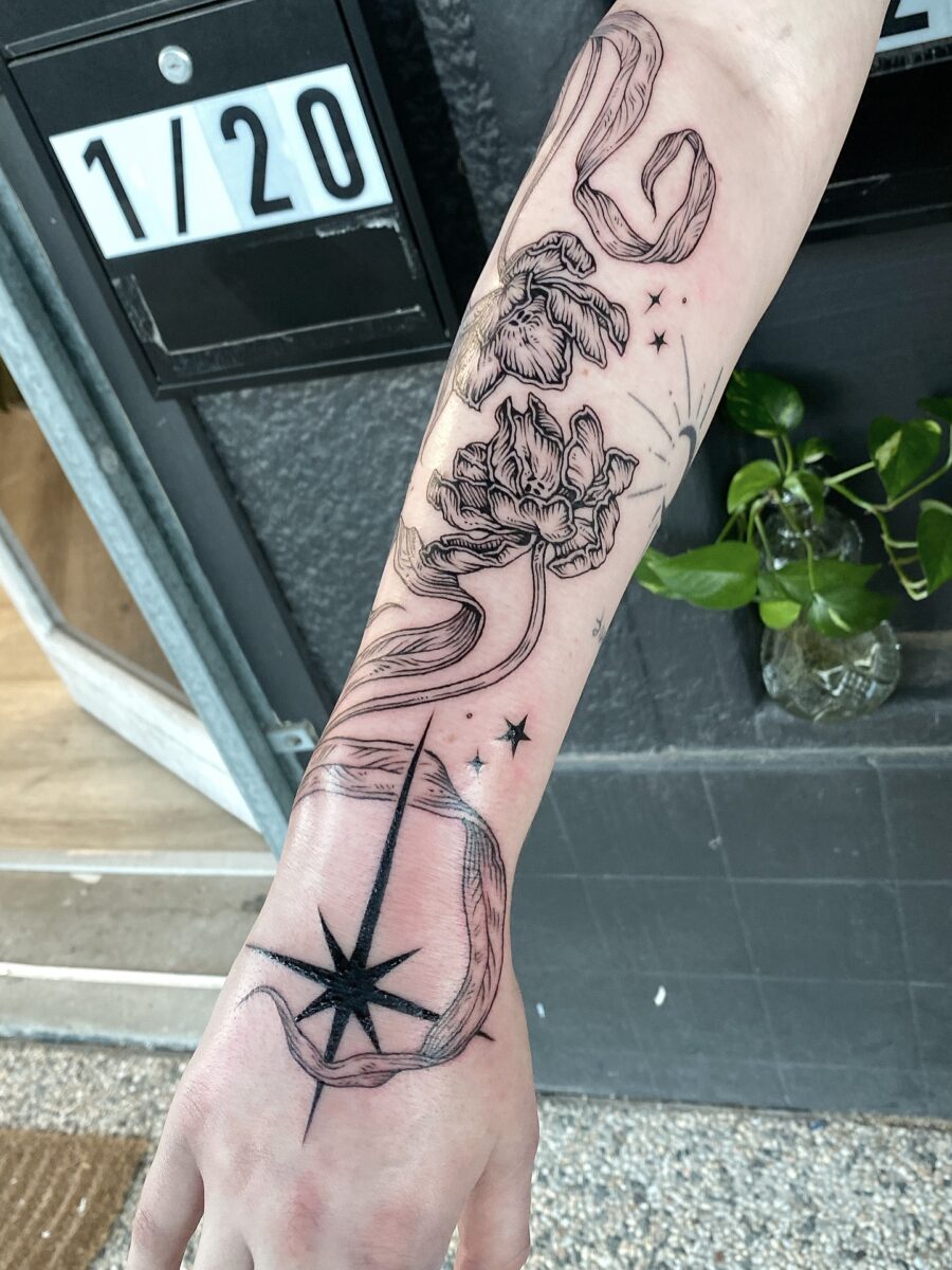 Elegant floral and compass half sleeve tattoo
