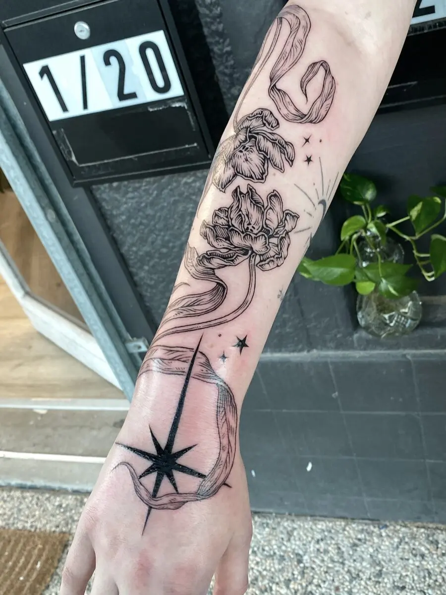 Elegant floral and compass half sleeve tattoo