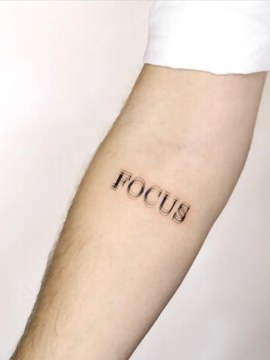 Minimalistic tattoo showcasing the word 'Focus'