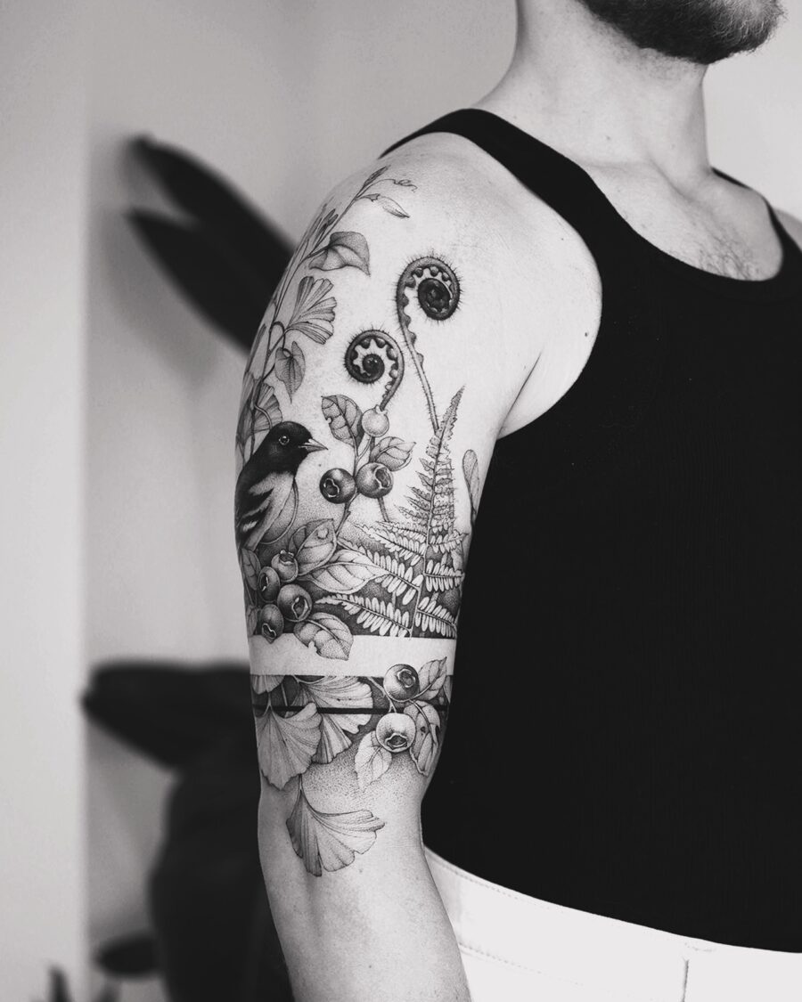 Intricate half sleeve tattoo featuring nature elements