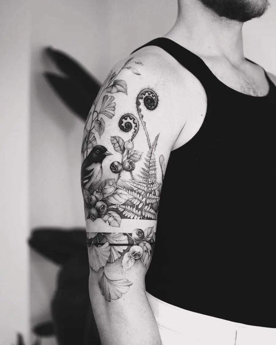 Intricate half sleeve tattoo featuring nature elements