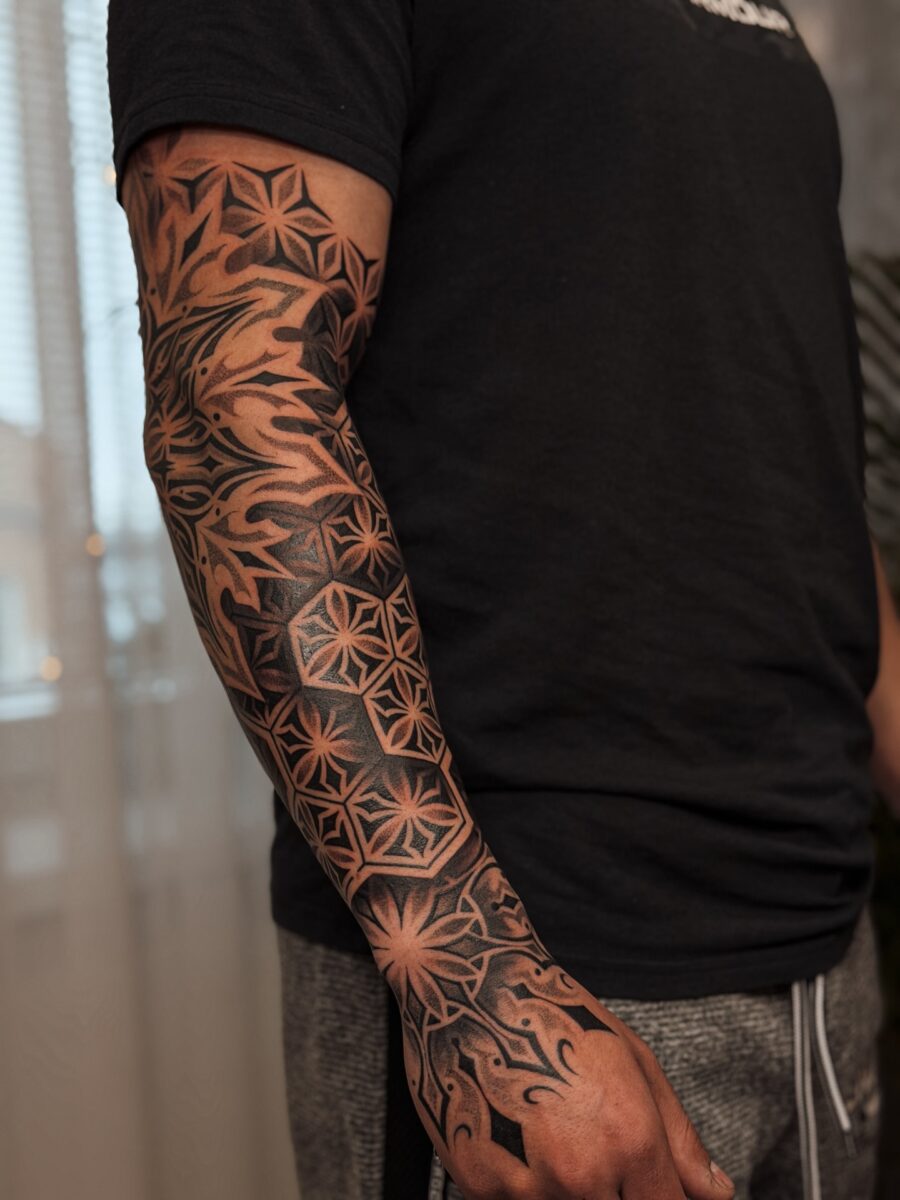 Intricate blackwork half sleeve tattoo design