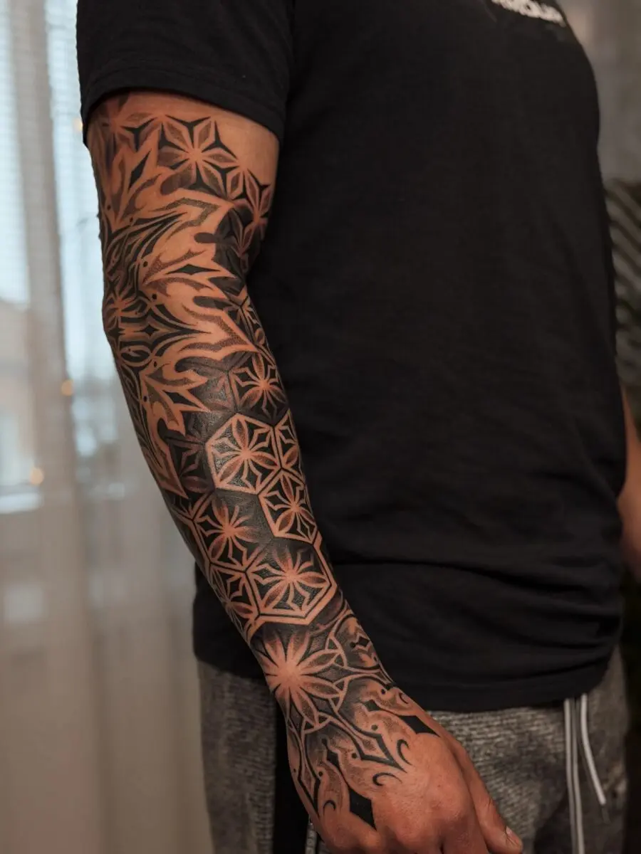 Intricate blackwork half sleeve tattoo design