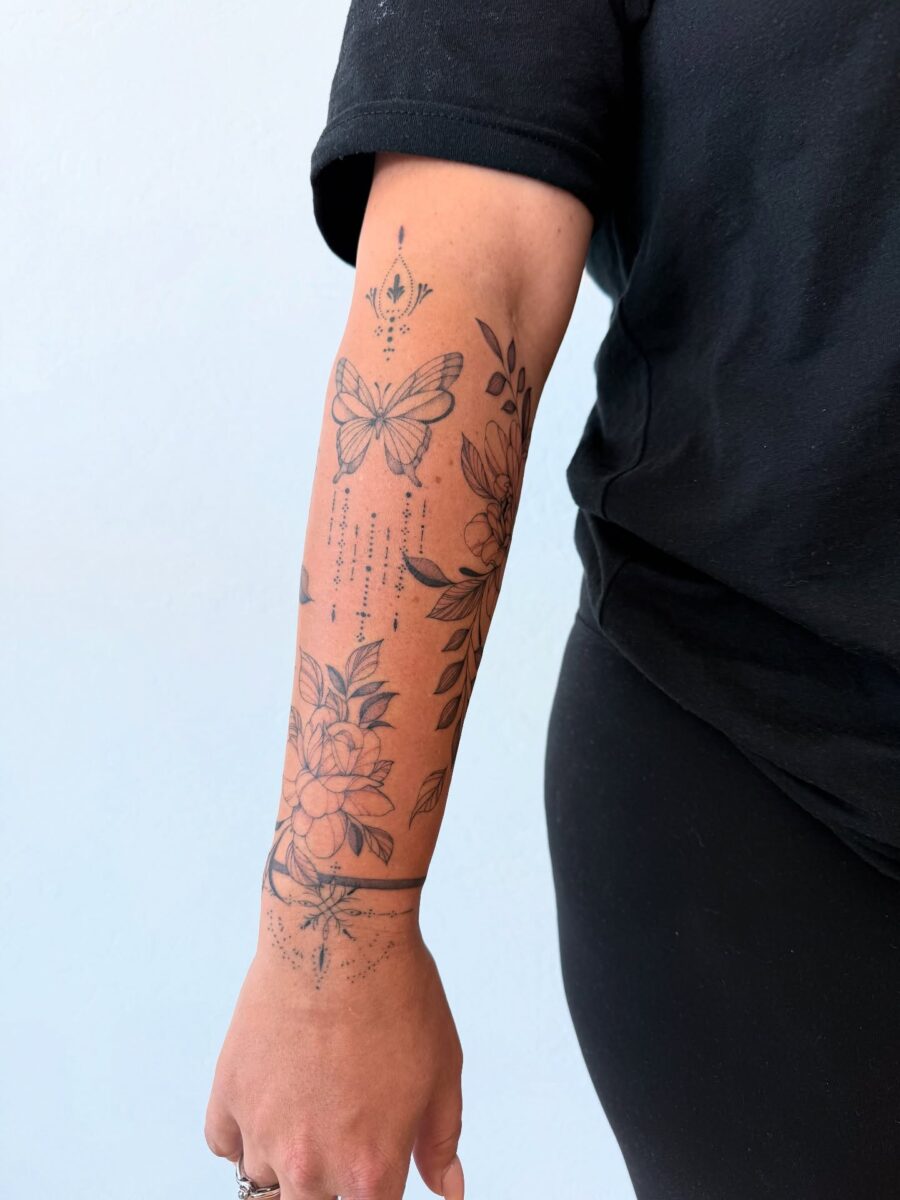 Elegant butterfly and floral half sleeve tattoo