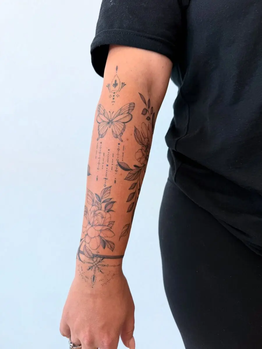 Elegant butterfly and floral half sleeve tattoo