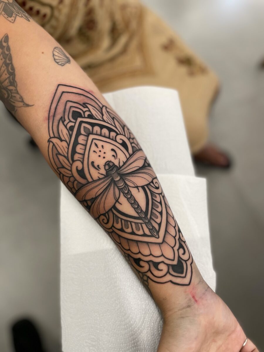Bold geometric moth half sleeve tattoo design
