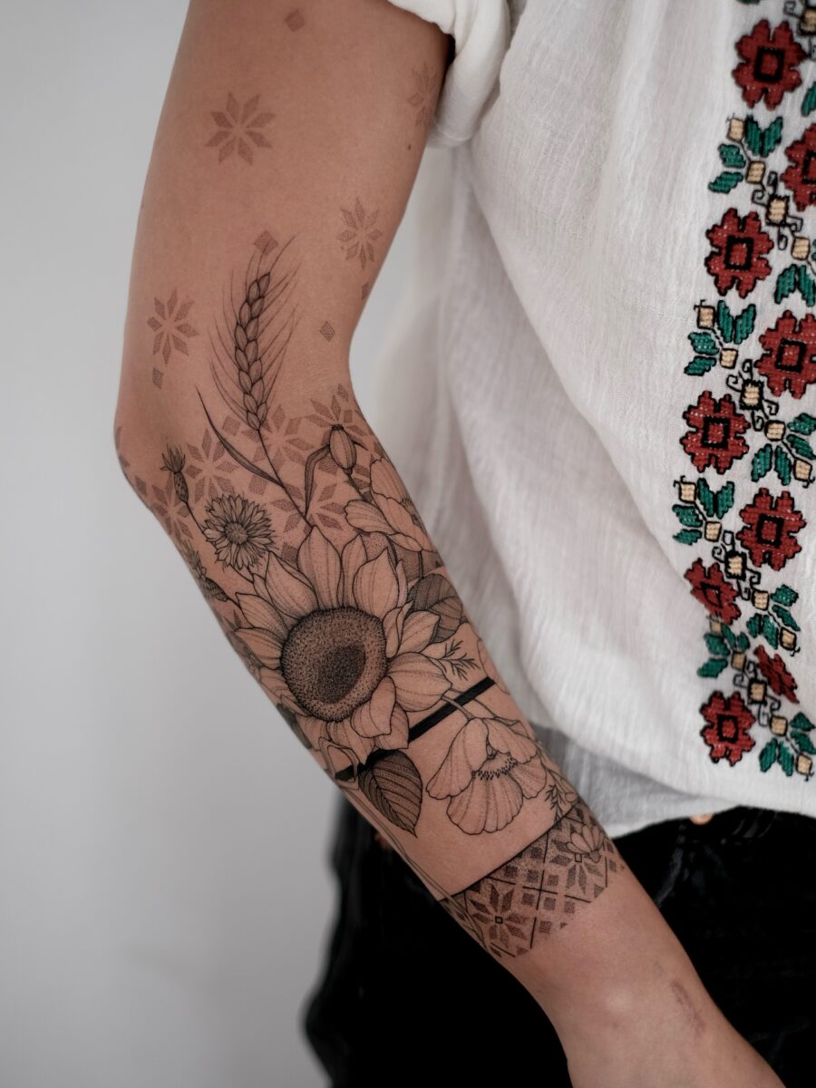 Elegant floral half sleeve tattoo design