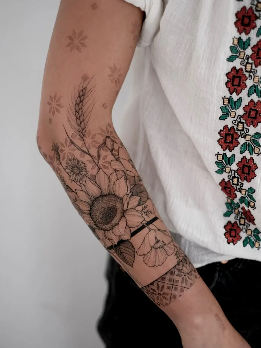 Elegant floral half sleeve tattoo design