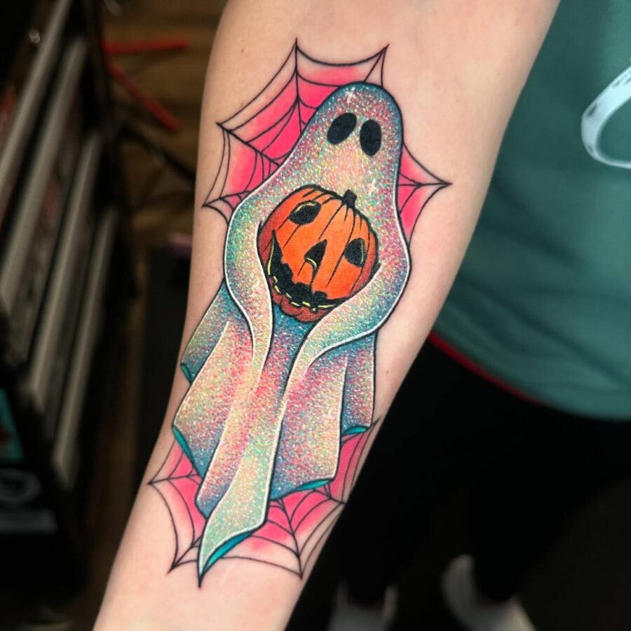 Charming ghost tattoo with vibrant pumpkin design