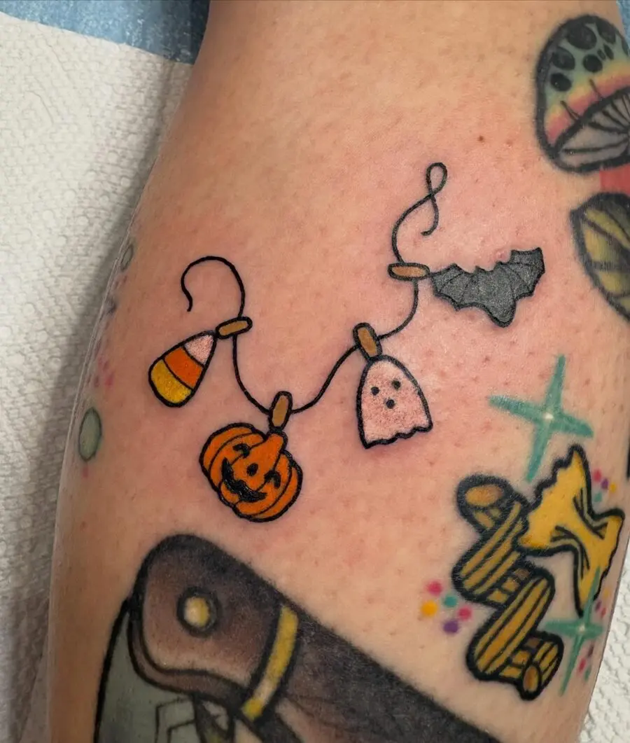Colorful Halloween-themed tattoo design with charm vibes