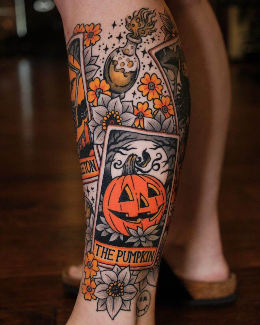 Unique pumpkin tattoo surrounded by flowers