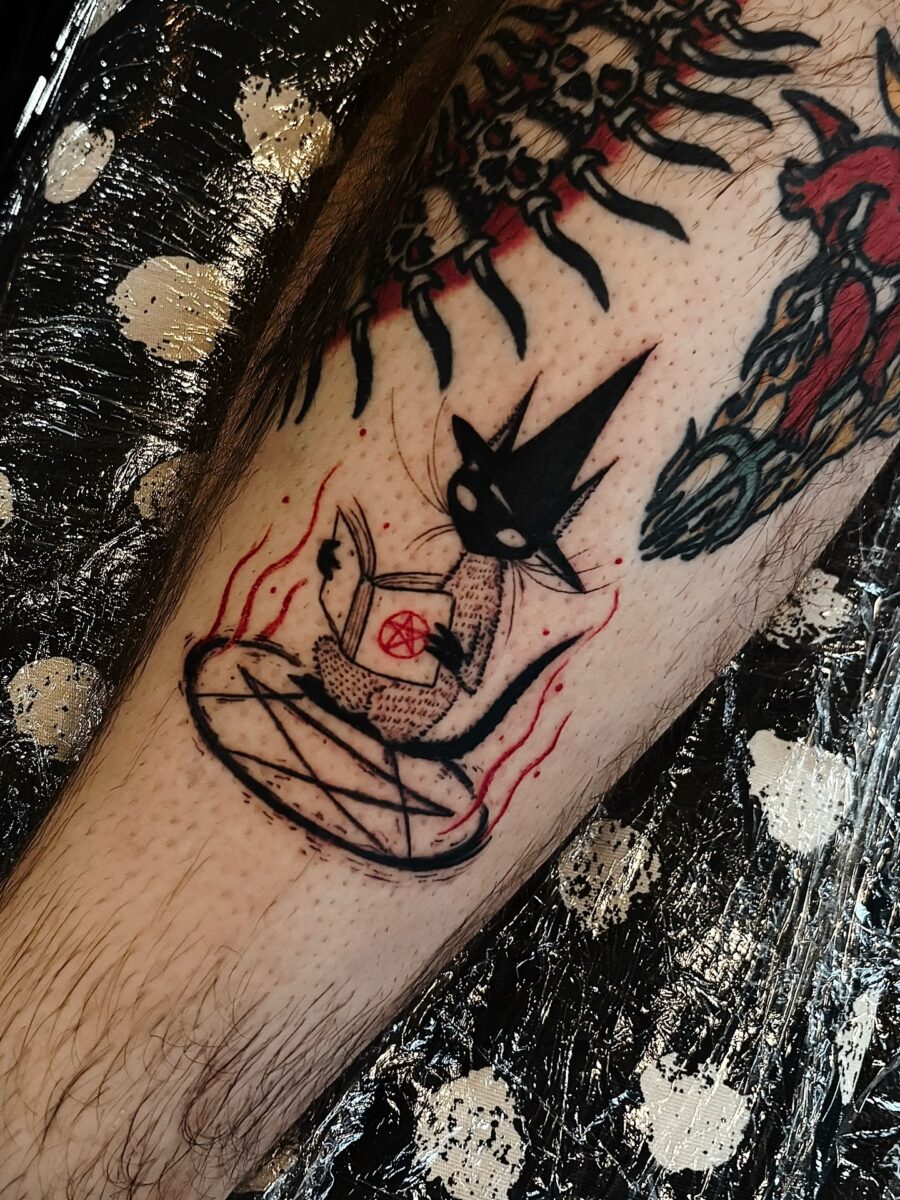 Charming witch cat casting a spell tattoo