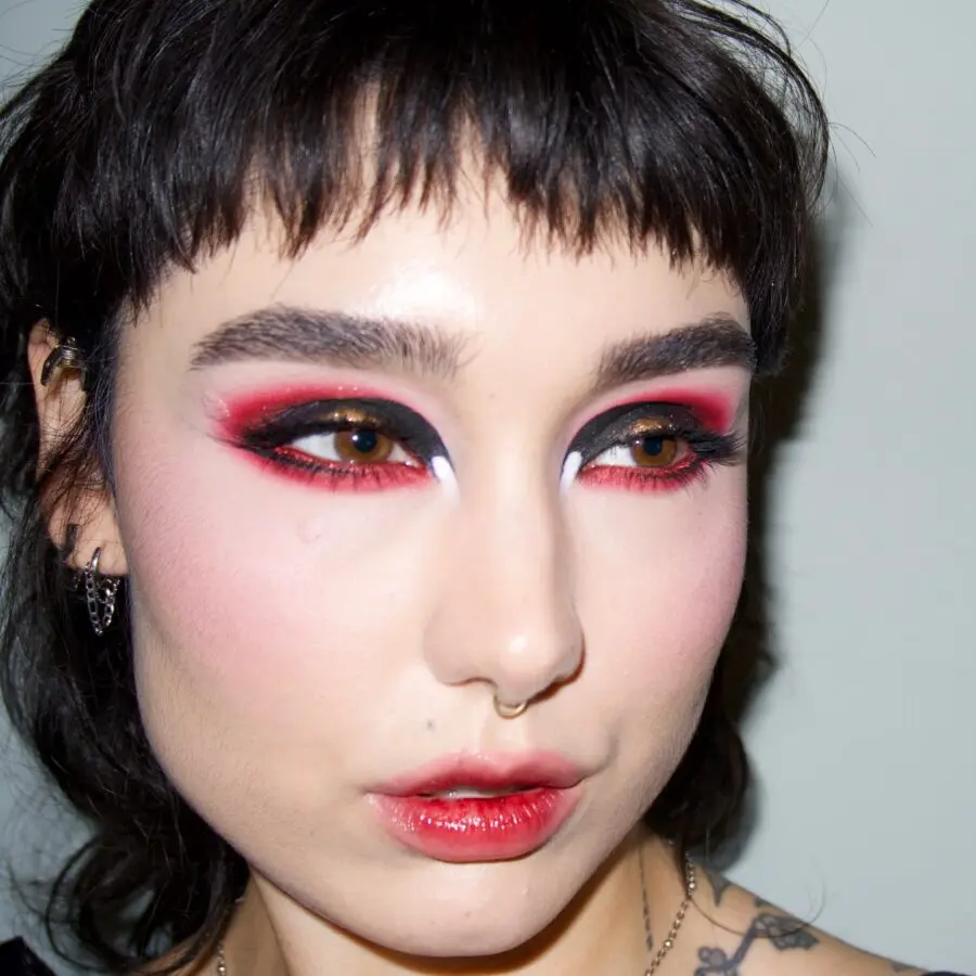 Bold halo eye makeup with red and black tones