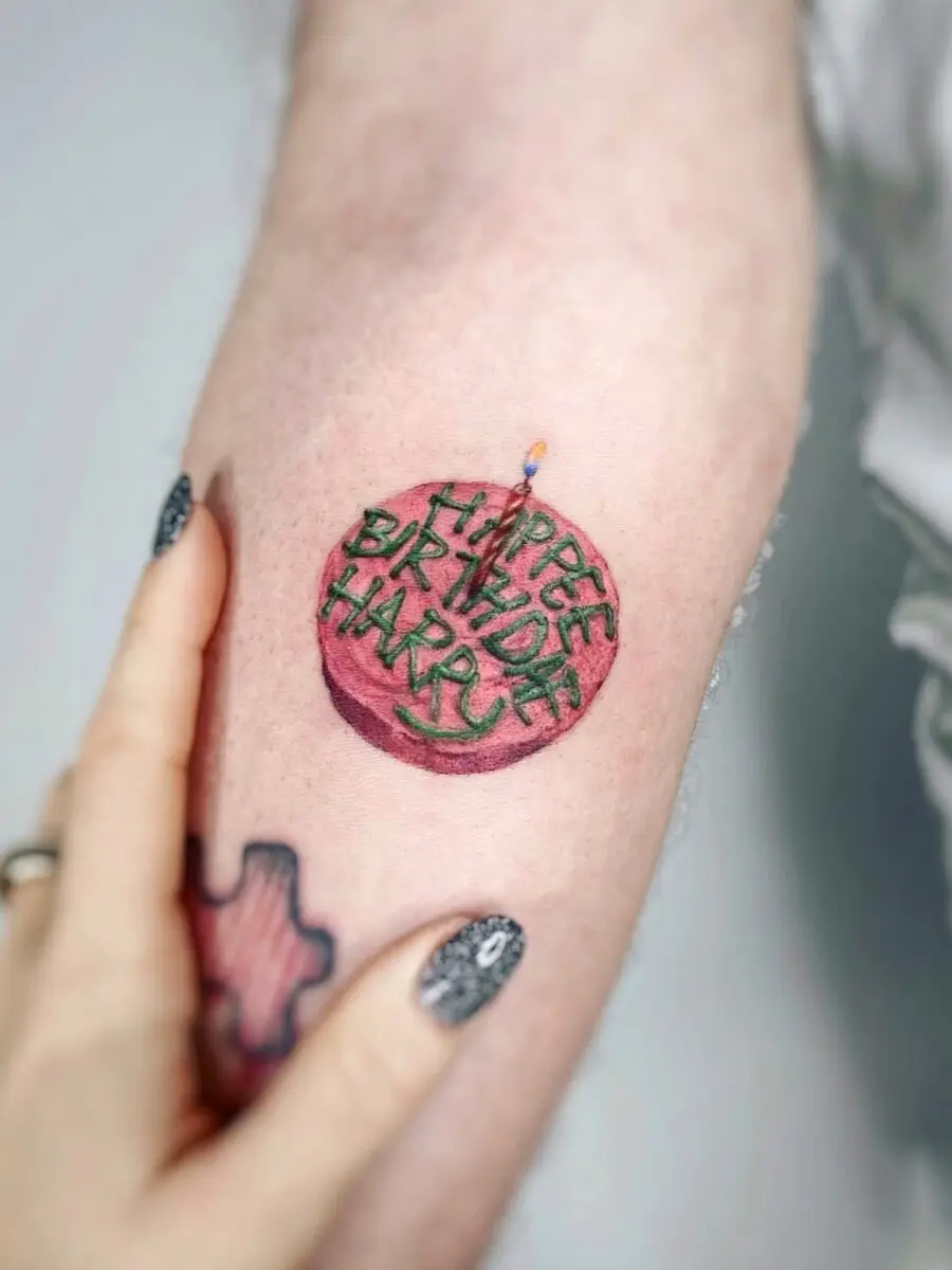 A vibrant birthday cake tattoo for special occasions