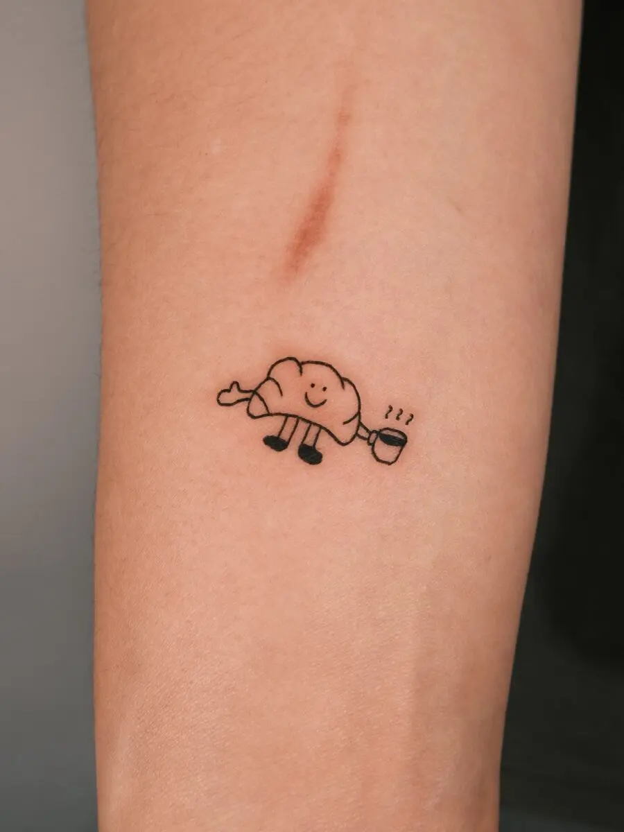 Cute croissant tattoo with joyful vibes