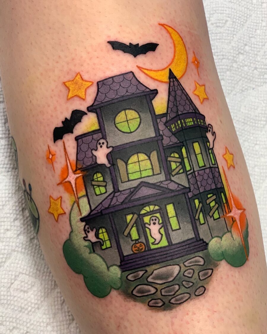 Charming haunted house tattoo with playful ghosts