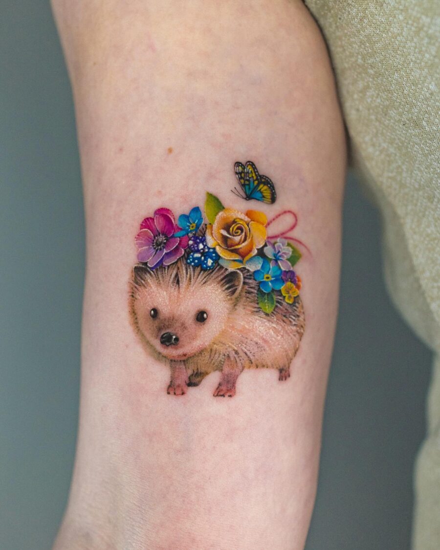 Cute hedgehog tattoo adorned with flowers