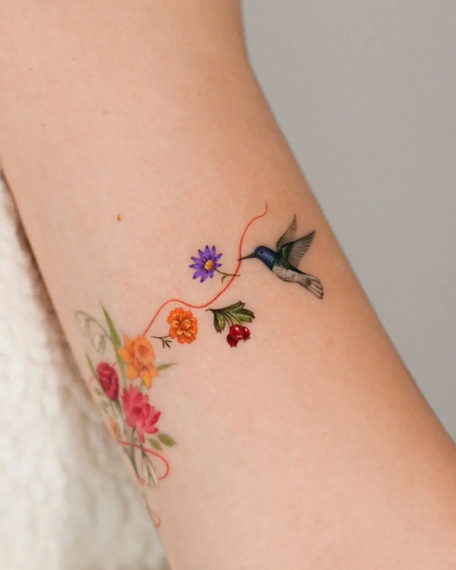Vibrant hummingbird and floral tattoo design