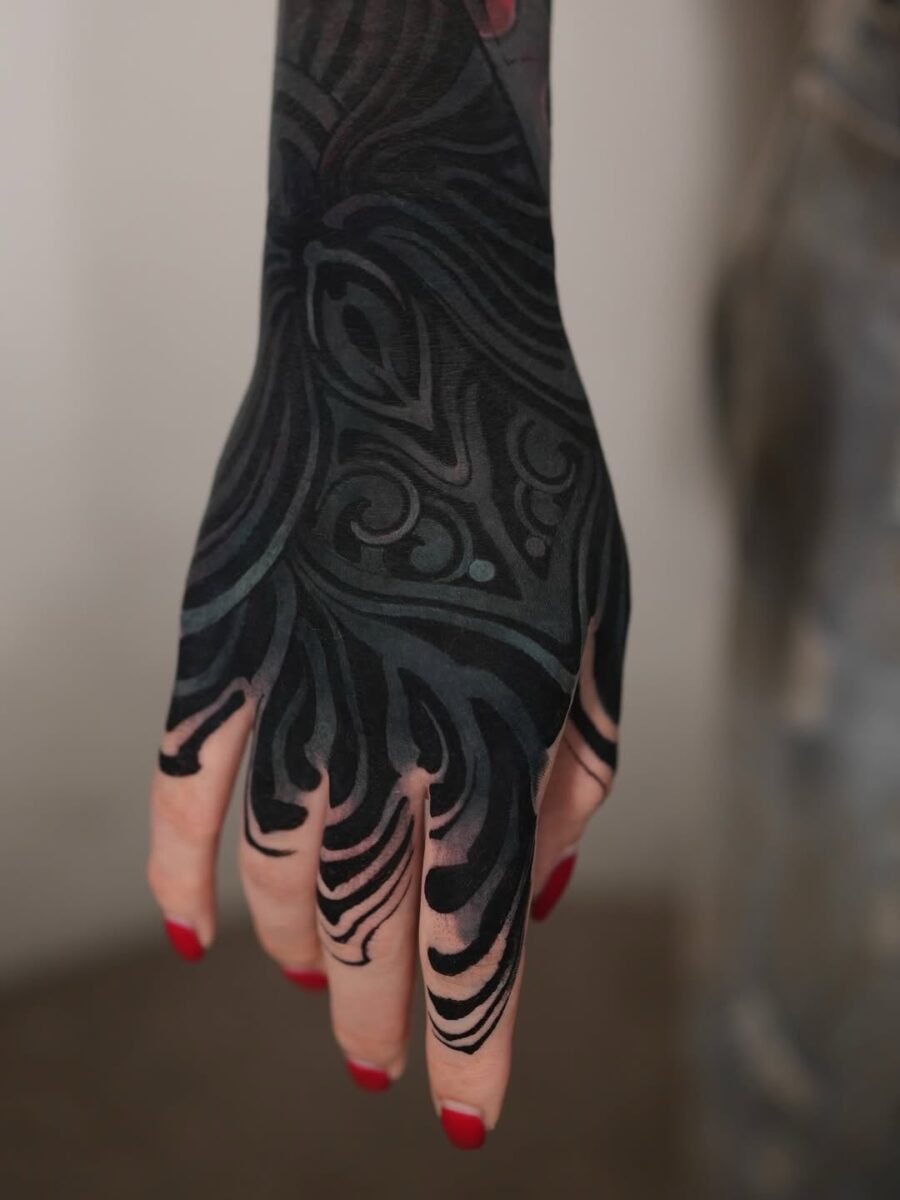 Stunning black sleeve tattoo on a hand