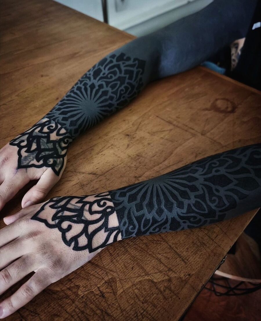 Intricate patterns define this striking sleeve tattoo