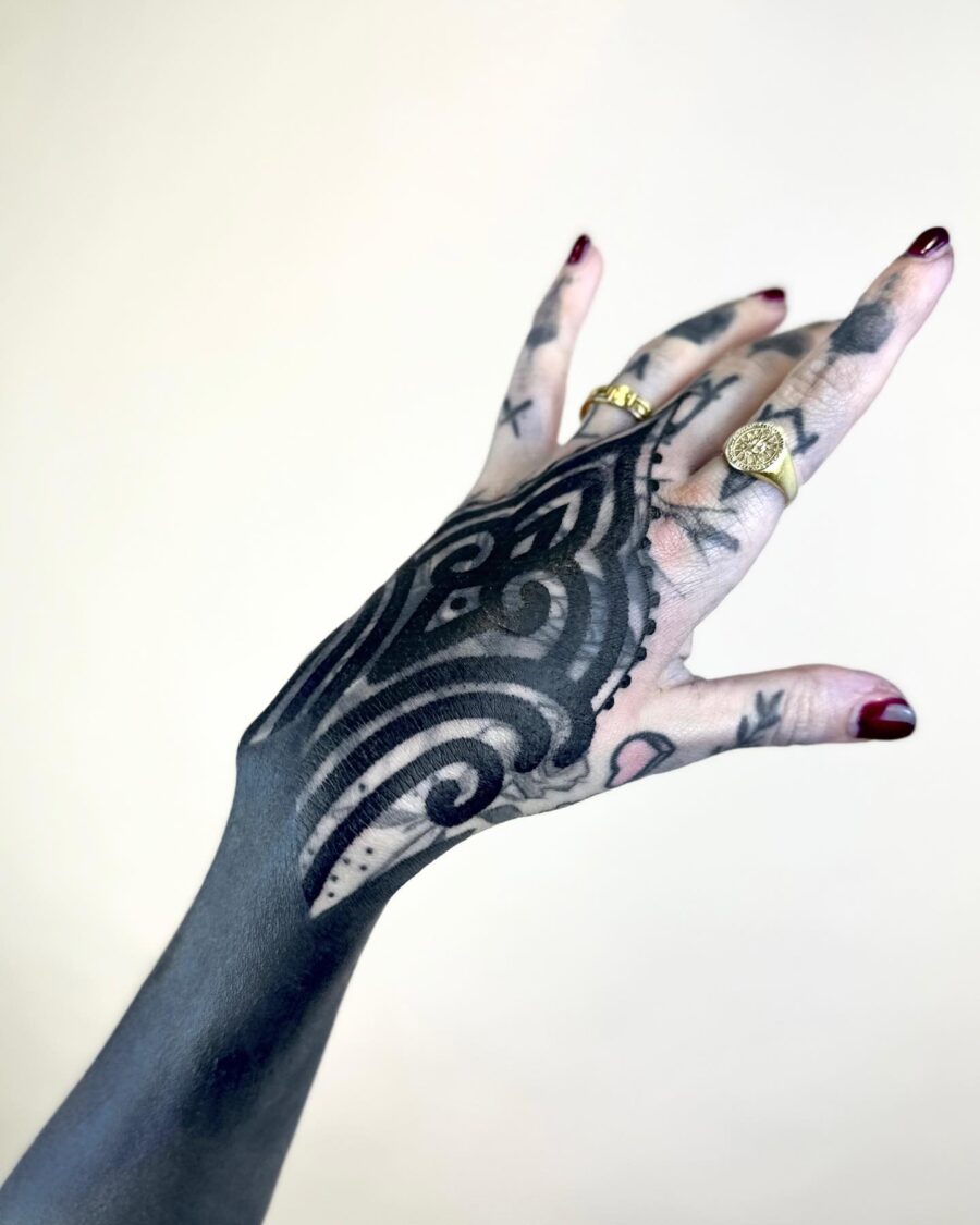 Intricate black sleeve tattoo showcasing elegance and artistry